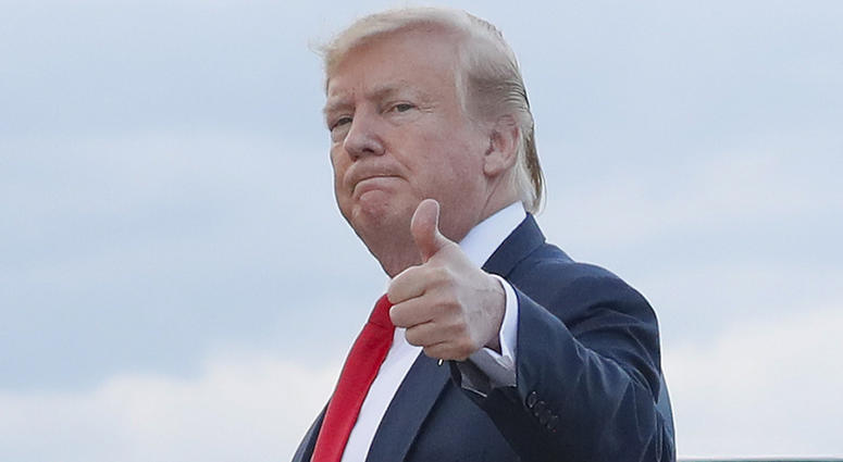 In this April 21, 2019 photo, President Donald Trump gives a 'thumbs-up' as he walks across the tarmac during his arrival on Air Force One at Andrews Air Force Base, Md. President Donald Trump