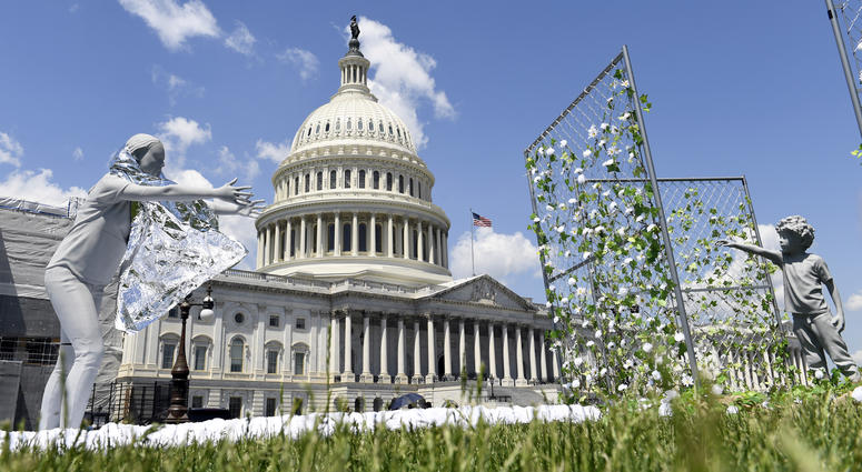 An art installation, on display outside the Capitol in Washington, Tuesday, May 7, 2019, shows a mother reaching out to her child to mark the first anniversary of the Trump administration's "zero tolerance" family separation policy. An art installation