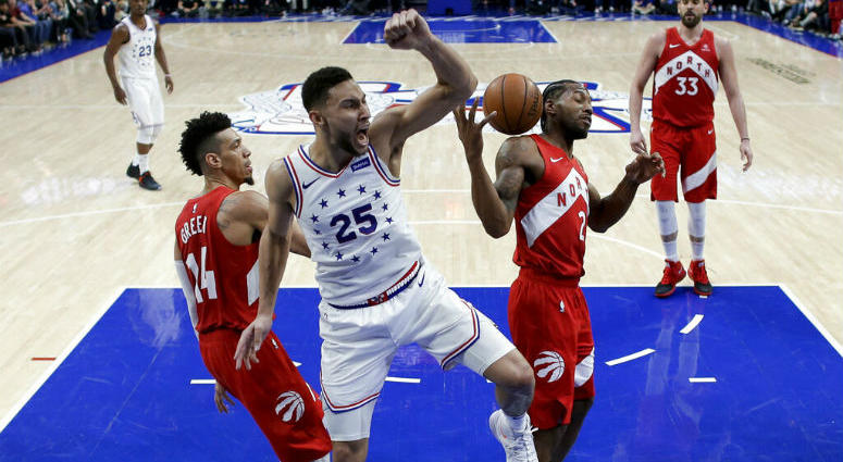 Philadelphia 76ers' Ben Simmons (25) reacts after dunking the ball between Toronto Raptors' Danny Green (14) and Kawhi Leonard (2) during the second half of Game 6 of a second-round NBA basketball playoff series Thursday, May 9, 2019, in Philadelphia. Philadelphia 76ers' Ben Simmons (25) reacts after dunking the ball between Toronto Raptors' Danny Green (14) and Kawhi Leonard (2) during the second half of Game 6 of a second-round NBA basketball playoff series Thursday, May 9, 2019, in Philadelphia.