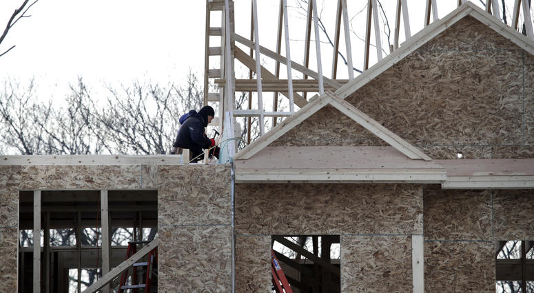 In this Jan. 23, 2019, file photo, construction workers build new housing in Salisbury, Mass. Construction workers build new housing.