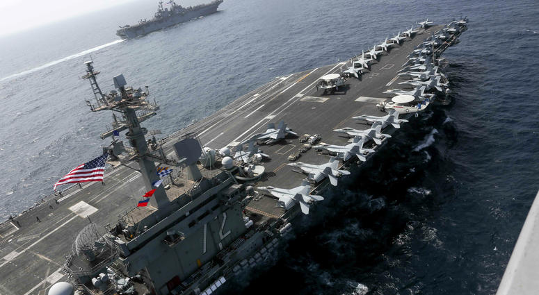 In this Friday, May 17, 2019, photo released by the U.S. Navy, the USS Abraham Lincoln sails in the Arabian Sea near the amphibious assault ship USS Kearsarge. USS Abraham Lincoln sails in the Arabian Sea.