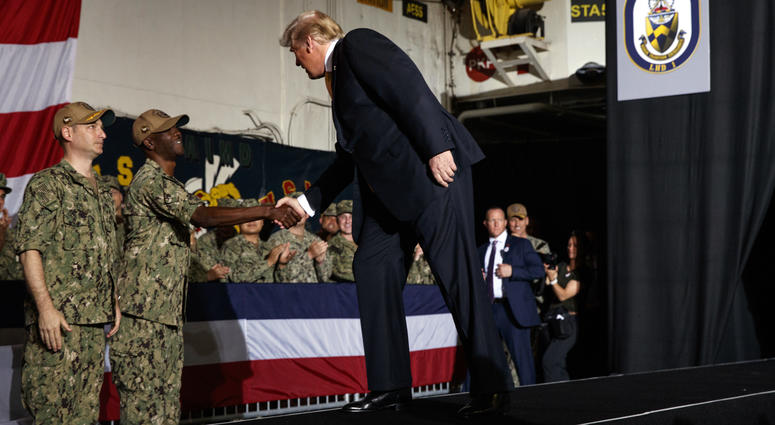 President Donald Trump arrives on stage to speak to troops at a Memorial Day event aboard the USS Wasp, Tuesday, May 28, 2019, in Yokosuka, Japan. President Donald Trump
