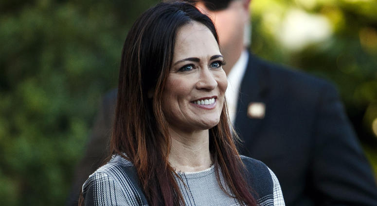 In this June 21, 2019 photo, Stephanie Grisham, spokeswoman for first lady Melania Trump, watches as President Donald Trump and the first lady greet attendees during the annual Congressional Picnic on the South Lawn in Washington. Stephanie Grisham