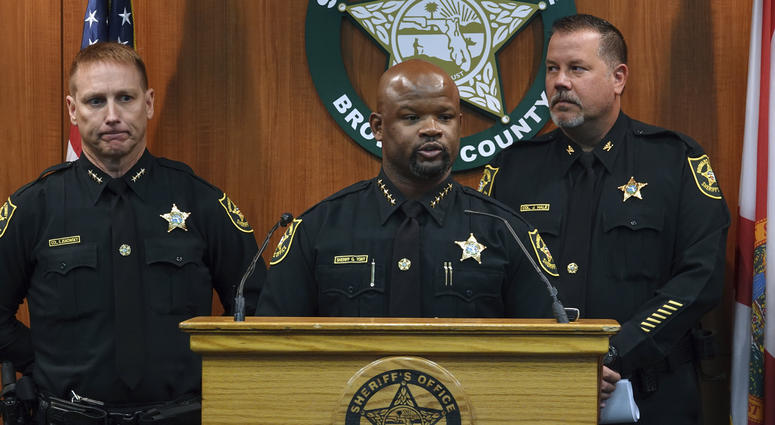 Broward Sheriff Gregory Tony, center, announces that two additional deputies have been fired as a result of the agency's internal affairs investigation into the mass shooting at Marjory Stoneman Douglas High School in Parkland, June 26, 2019. Broward County police