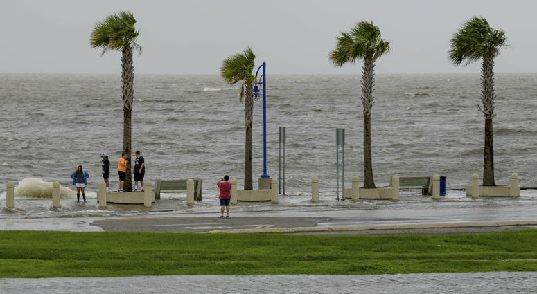 People check out the waves on Lakeshore Drive in New Orleans, La., Friday, July 12, 2019, as water moves in from Lake Pontchartrain from the storm surge from Tropical Storm Barry in the Gulf of Mexico. People check out the waves on Lakeshore Drive in New Orleans, La., Friday, July 12, 2019, as water moves in from Lake Pontchartrain from the storm surge from Tropical Storm Barry in the Gulf of Mexico.