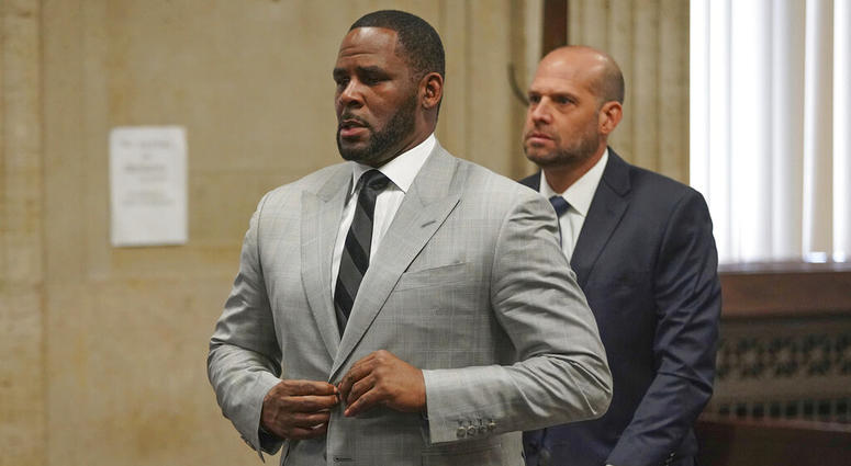 FILE - In this June 6, 2019, file photo, singer R. Kelly pleaded not guilty to 11 additional sex-related felonies during a court hearing before Judge Lawrence Flood at Leighton Criminal Court Building in Chicago. Kelly, who was arrested in Chicago on July 11, 2019 on a federal grand jury indictment listing 13 counts including sex crimes and obstruction of justice, was ordered held without bond on Tuesday, July 16.