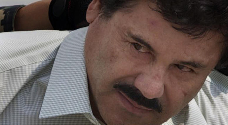 In this Feb. 22, 2014, file photo, Joaquin "El Chapo" Guzman is escorted to a helicopter in handcuffs by Mexican navy marines at a navy hanger in Mexico City. In this Feb. 22, 2014, file photo, Joaquin "El Chapo" Guzman is escorted to a helicopter in handcuffs by Mexican navy marines at a navy hanger in Mexico City.