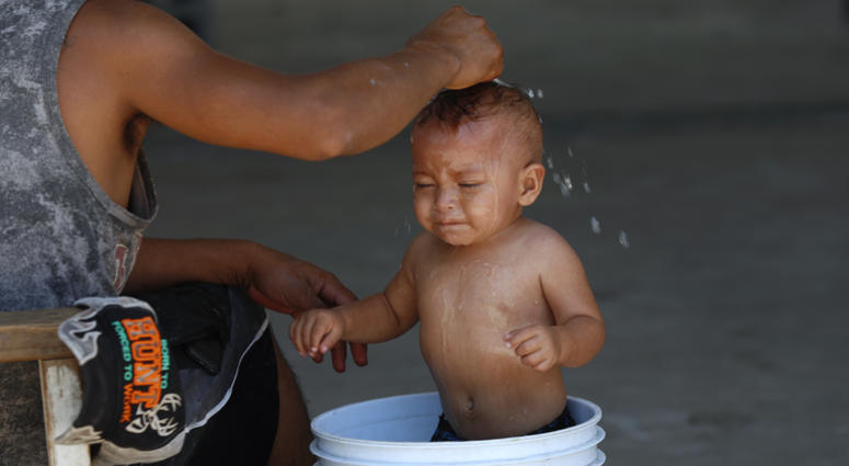 A migrant baby is given a bath at the AMAR migrant shelter in Nuevo Laredo, Mexico, Tuesday, July 16, 2019. A migrant baby is given a bath at the AMAR migrant shelter in Nuevo Laredo, Mexico, Tuesday, July 16, 2019.