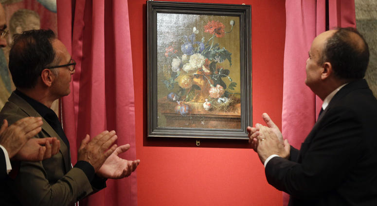 German Foreign Minister Heiko Mass, left, and Italian Culture Minister Alberto Bonisoli watch the unveiling of the "Vase of Flowers" painting by Jan van Huysum, at the Pitti Palace, part of the Uffizi Galleries, in Florence, Italy, Friday, July 19, 2019. German Foreign Minister Heiko Mass, left, and Italian Culture Minister Alberto Bonisoli watch the unveiling of the "Vase of Flowers" painting by Jan van Huysum, at the Pitti Palace, part of the Uffizi Galleries, in Florence, Italy, Friday, July 19, 2019.