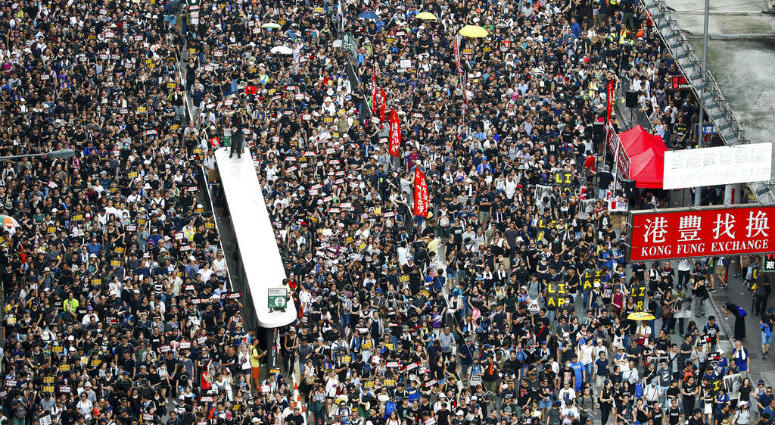 Protesters take part in a march on a street in Hong Kong, Sunday, July 21, 2019. Thousands of Hong Kong protesters marched from a public park to call for an independent investigation into police tactics. Protesters take part in a march on a street in Hong Kong, Sunday, July 21, 2019. Thousands of Hong Kong protesters marched from a public park to call for an independent investigation into police tactics.