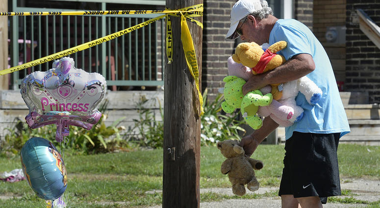 Paul Laughlin, 57, places stuffed animals on Sunday, Aug. 11, 2019 outside a home at 1248 West 11th St. in Erie, Pa., where multiple people died in an early-morning fire. Paul Laughlin, 57, places stuffed animals on Sunday, Aug. 11, 2019 outside a home at 1248 West 11th St. in Erie, Pa., where multiple people died in an early-morning fire.
