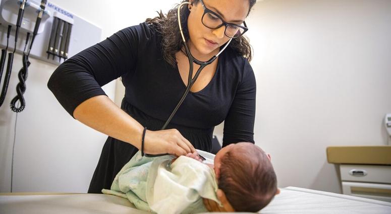 Dr. Jasmine Saavedra, a pediatrician at Esperanza Health Centers whose parents emigrated from Mexico in the 1980s, examines Alondra Marquez, a newborn baby in her clinic in Chicago. Dr. Jasmine Saavedra