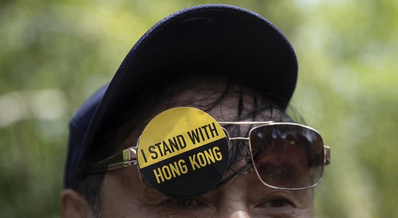 A man with a sticker that reads "I Stand With Hong Kong" on his glasses gathered with others in Lafayette Square in front of the White House, Aug. 18, 2019, in solidarity with the "Stand With Hong Kong, Power to the People Rally" in Hong Kong. Hong Kong