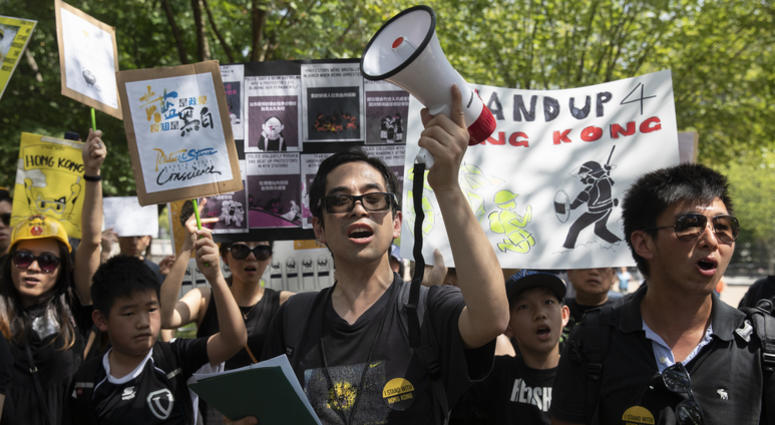 People gather in Lafayette Square in front of the White House in Washington, Sunday, Aug. 18, 2019, in solidarity with the "Stand With Hong Kong, Power to the People Rally" in Hong Kong. People gather in Lafayette Square in front of the White House in Washington, Sunday, Aug. 18, 2019, in solidarity with the "Stand With Hong Kong, Power to the People Rally" in Hong Kong.