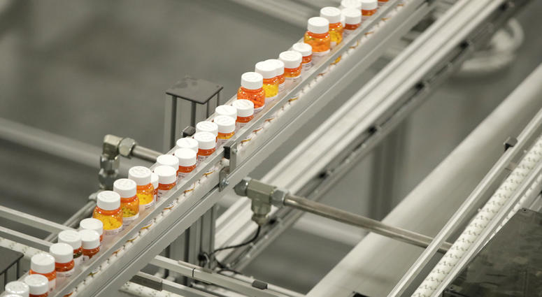 In this July 10, 2018, file photo bottles of medicine ride on a belt at a mail-in pharmacy warehouse in Florence, N.J. In this July 10, 2018, file photo bottles of medicine ride on a belt at a mail-in pharmacy warehouse in Florence, N.J.