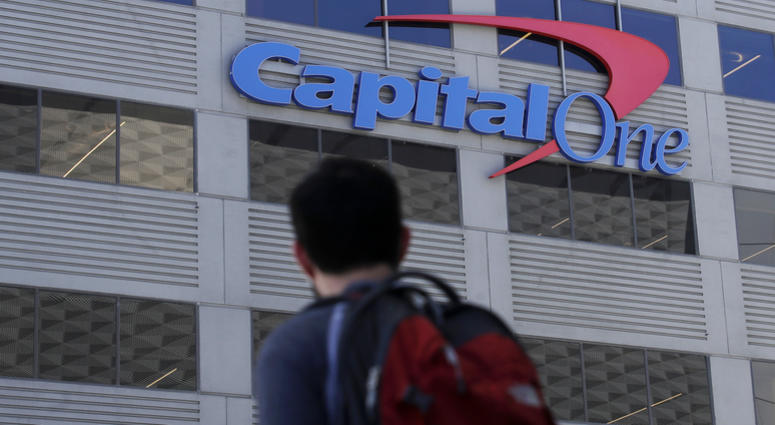 In this July 16, 2019, file photo, a man walks across the street from a Capital One location in San Francisco. Capital One