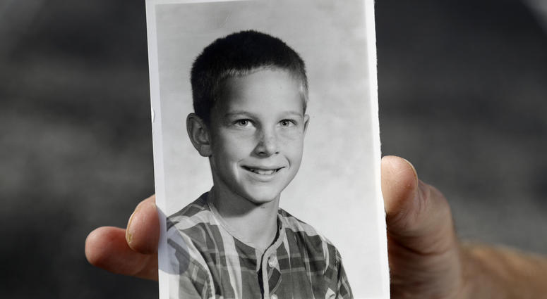 In this Wednesday, Aug. 21, 2019 photo, Greg Hunt holds a school photo of himself in St. Petersburg, Fla. Greg Hunt holds a school photo of himself.