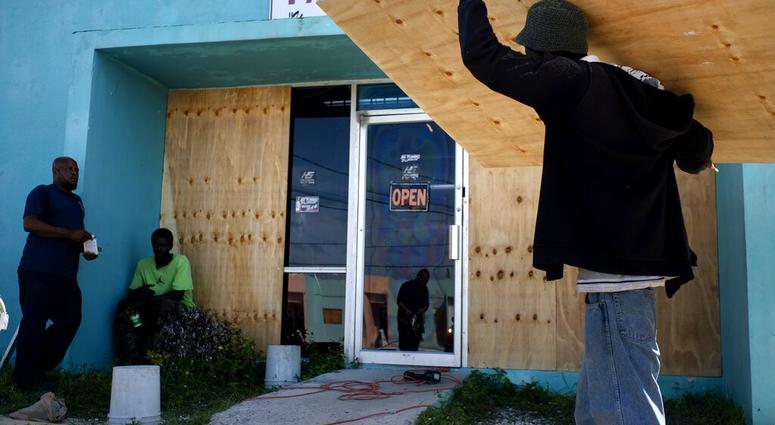 Workers board up a shop’s window front as they make preparations for the arrival of Hurricane Dorian, in Freeport, Bahamas, Friday, Aug. 30, 2019. Workers board up a shop’s window front as they make preparations for the arrival of Hurricane Dorian, in Freeport, Bahamas, Friday, Aug. 30, 2019.