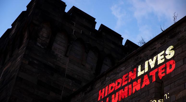A new exhibit titled "Hidden Lives Illuminated" is projected on a wall of the Eastern State Penitentiary, a former prison that's now a museum. A new exhibit titled "Hidden Lives Illuminated" is projected on a wall of the Eastern State Penitentiary, a former prison that's now a museum.