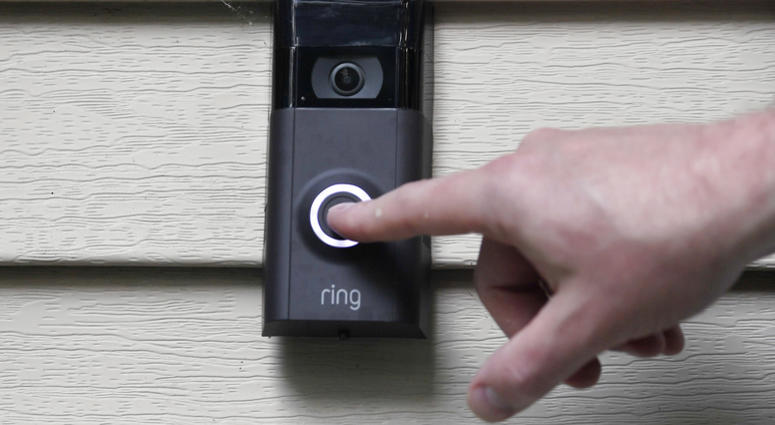 In this Tuesday, July 16, 2019, file photo, Ernie Field pushes the doorbell on his Ring doorbell camera at his home in Wolcott, Conn. Ring doorbell camera