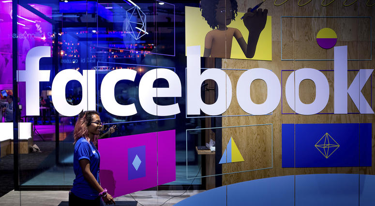 April 18, 2017: A conference worker passes a demo booth at Facebook's annual F8 developer conference, in San Jose, Calif. April 18, 2017: A conference worker passes a demo booth at Facebook's annual F8 developer conference, in San Jose, Calif.