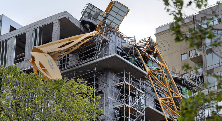 A toppled building crane is draped over a new construction project after Hurricane Dorian swept through the area in Halifax, Nova Scotia, on Sunday, Sept. 8, 2019. toppled building crane