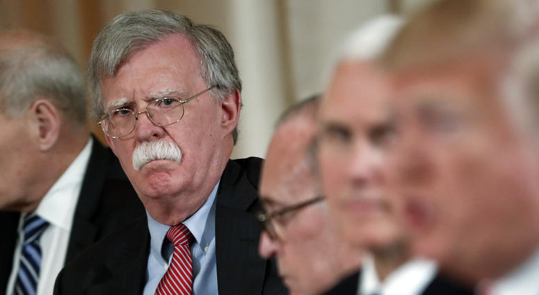 In this April 18, 2018 file photo, National security adviser John Bolton, left, listens to President Donald Trump, far right, speak during a working lunch with Japanese Prime Minister Shinzo Abe at Trump' s private Mar-a-Lago club in Palm Beach, Fla. John Bolton