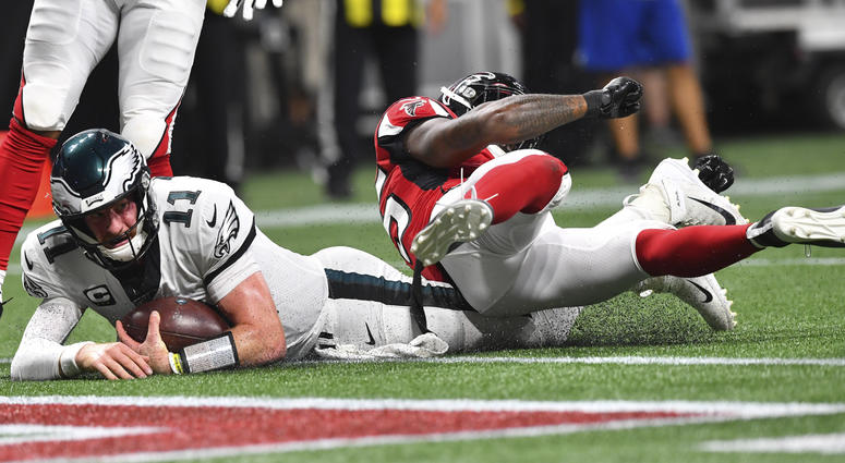 Philadelphia Eagles quarterback Carson Wentz (11) hits the turf near the goal line working for a two-point conversion against the Atlanta Falcons during the second half of an NFL football game, Sunday, Sept. 15, 2019, in Atlanta. Philadelphia Eagles quarterback Carson Wentz (11) hits the turf near the goal line working for a two-point conversion against the Atlanta Falcons during the second half of an NFL football game, Sunday, Sept. 15, 2019, in Atlanta.