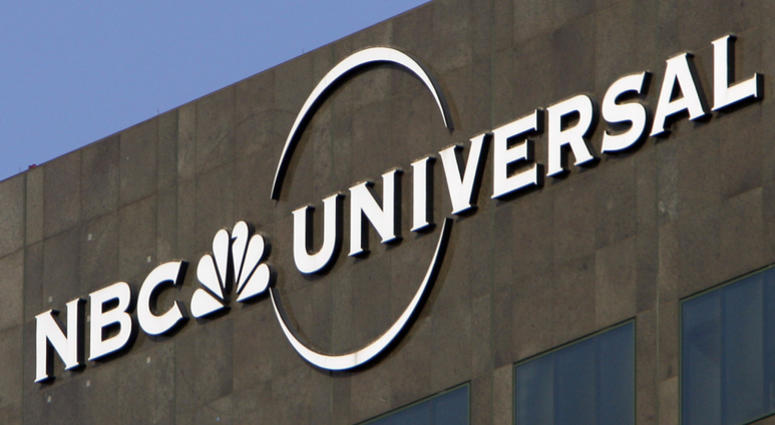 This Dec. 3, 2009, file photo, the NBC Universal logo hangs on a building in Los Angeles. NBC Universal