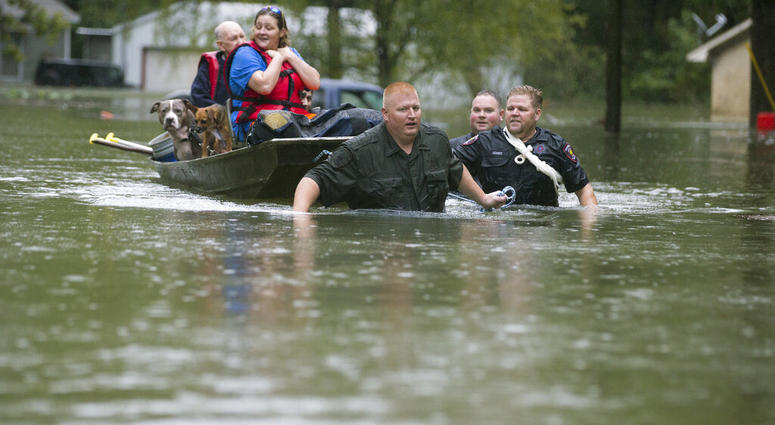Splendora Police Lt. Troy Teller, left, Cpl. Jacob Rutherford and Mike Jones pull a boat carrying Anita McFadden and Fred Stewart from their flooded neighborhood inundated by rain from Tropical Depression Imelda on Thursday, Sept. 19, 2019, in Spendora, T Splendora Police Lt. Troy Teller, left, Cpl. Jacob Rutherford and Mike Jones pull a boat carrying Anita McFadden and Fred Stewart from their flooded neighborhood inundated by rain from Tropical Depression Imelda.