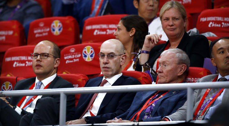 In this Sept. 13, 2019, file photo, NBA Commissioner Adam Silver, second from left, attends the semifinal match between Argentina and France in the FIBA Basketball World Cup at the Cadillac Arena in Beijing. NBA Commissioner Adam Silver