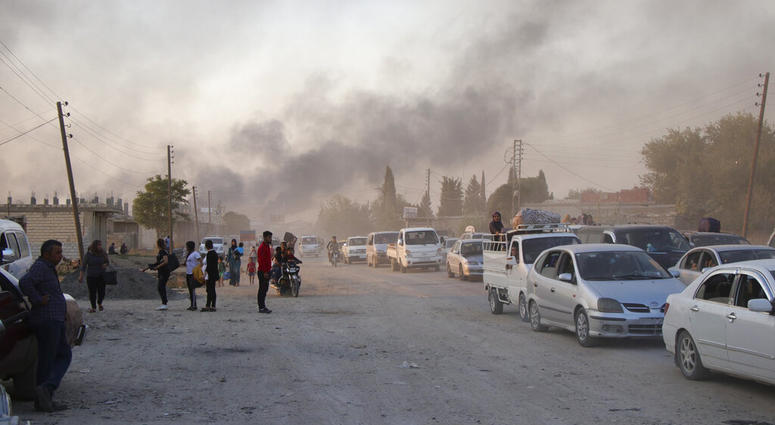 Syrians flee shelling by Turkish forces in Ras al Ayn, northeast Syria, Wednesday, Oct. 9, 2019. Syrians flee shelling by Turkish forces in Ras al Ayn, northeast Syria.