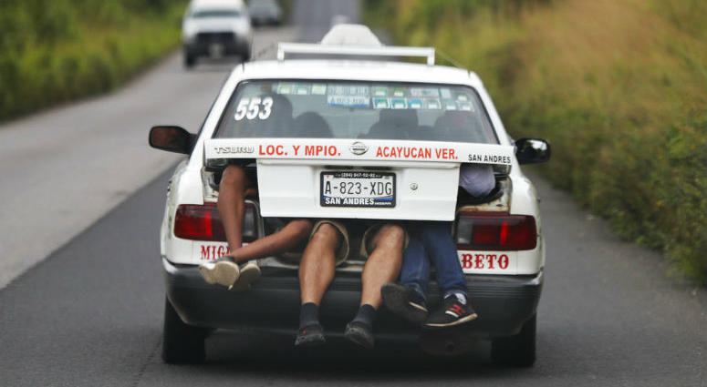 Central American migrants, part of the caravan hoping to reach the U.S. border, a ride on in the trunk of a taxi, in Acayucan, Veracruz state, Mexico, Saturday, Nov. 3, 2018.
