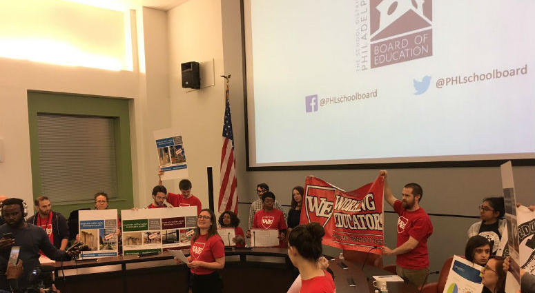 In this photo, activists opposed to the policy then disrupted Friday night's meeting as a divided school board has approved a policy requiring all district high schools to use walk-through metal detectors. Activists opposed to the policy then disrupted Friday night's meeting as a divided school board has approved a policy requiring all district high schools to use walk-through metal detectors.