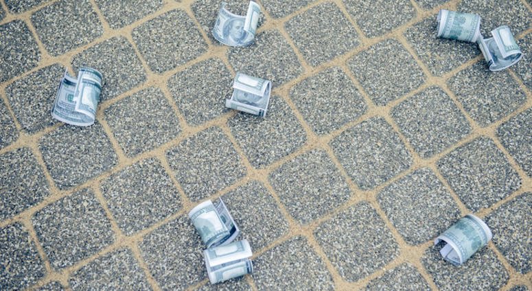 Dollar bills on asphalt road money of road