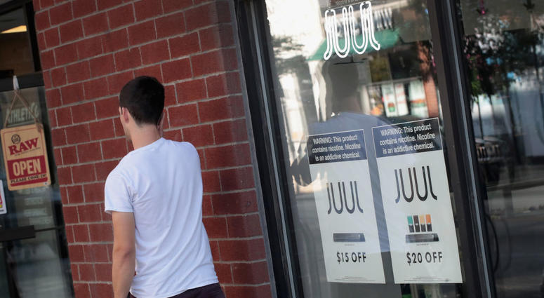 Signs in the window of the Smoke Depot advertise electronic cigarettes and pods by Juul, the nation's largest maker of e-cigarette products, on September 13, 2018 in Chicago, Illinois. Signs in the window of the Smoke Depot advertise electronic cigarettes and pods by Juul, the nation's largest maker of e-cigarette products, on September 13, 2018 in Chicago, Illinois.
