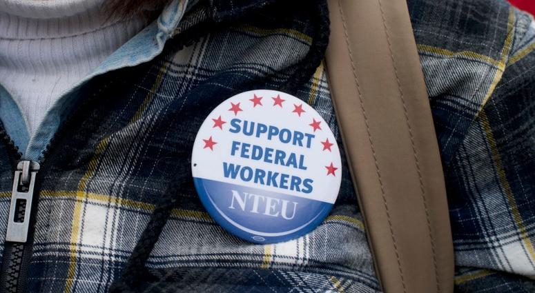A woman wears a National Treasury Employees Union pin stating "SUPPORT FEDERAL WORKERS" while joining area elected officials and furloughed federal workers at a rally in front of Independence Hall on Jan. 8, 2019. A woman wears a National Treasury Employees Union pin stating "SUPPORT FEDERAL WORKERS" while joining area elected officials and furloughed federal workers at a rally in front of Independence Hall on Jan. 8, 2019.