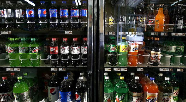 Various bottles of soda are displayed in a cooler at Marina Supermarket on July 22, 2014 in San Francisco, California. Various bottles of soda are displayed in a cooler.