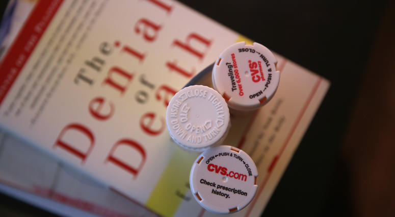 Bottles of prescription medicines stand on reading material about the right to die, March 16, 2016, New York City. Right to die