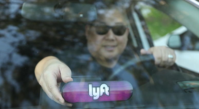 A Lyft driver places the Amp on his dashboard on Jan. 31, 2017 in San Francisco, California. A Lyft driver places the Amp on his dashboard.