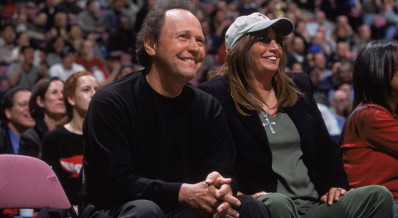 Actor Billy Crystal and movie director Penny Marshall watch the NBA game between the Los Angeles Clippers and the New Jersey Nets at Continental Airlines Arena in East Rutherford, New Jersey, on Jan. 10, 2002. Billy Crystal and Penny Marshall