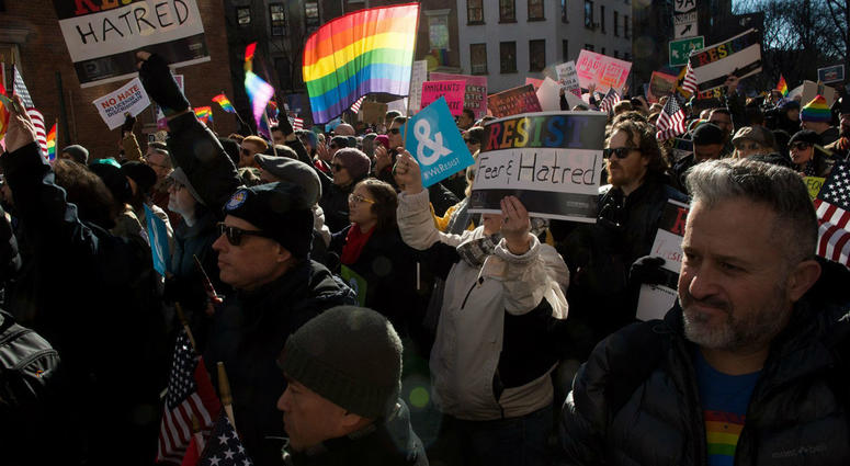 The Human Rights Campaign on Sunday called for the Trump administration not to go forward with a rollback of protections for transgender people, following a report in The New York Times on a draft proposal. People hold signs and flags at a rally