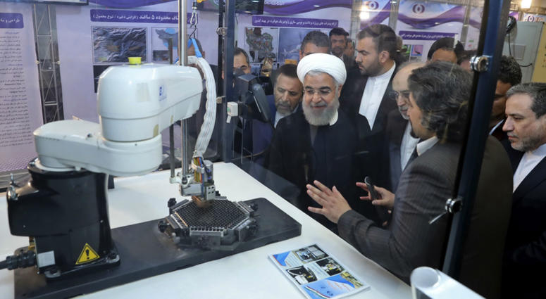 President Hassan Rouhani listens to explanations on new nuclear achievements at a ceremony to mark "National Nuclear Day," in Tehran, Iran. President Hassan Rouhani listens to explanations on new nuclear achievements at a ceremony to mark "National Nuclear Day," in Tehran, Iran.