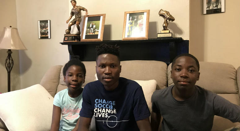 Daniel Yallah (C) and his sister Prosper Yallah (L) and brother Winner Yallah (R). Philadelphia's Unity Cup lets Philadelphians from all over the globe compete against each other in a World Cup style soccer tournament.
