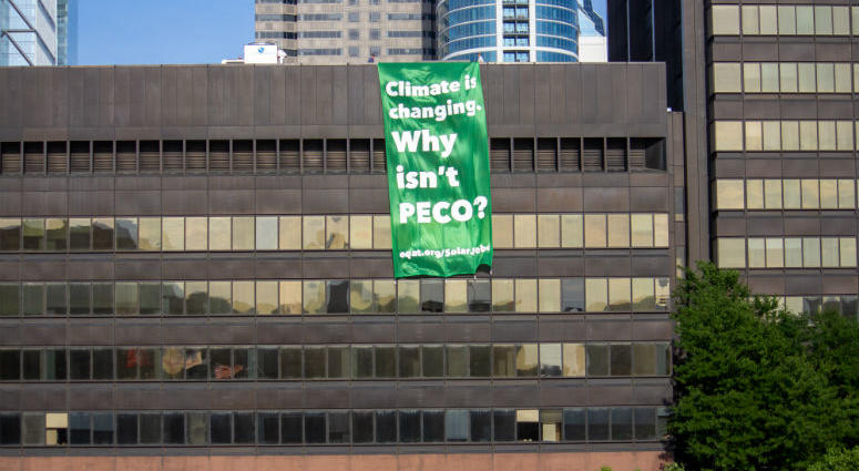 On a broiling mid-July afternoon, three activists from EQAT (pronounced "equate") were arrested for unfurling a banner from the roof of PECO's headquarters on Market Street declaring, "Climate is changing — Why isn't PECO?" On a broiling mid-July afternoon, three activists from EQAT (pronounced "equate") were arrested for unfurling a banner from the roof of PECO's headquarters on Market Street declaring, "Climate is changing — Why isn't PECO?"