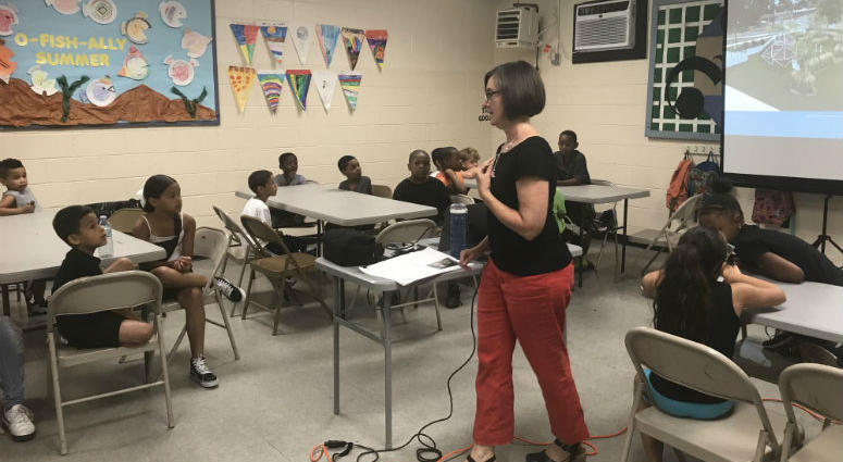 Julie Bush, principal at Ground Reconsidered, getting input on the Heitzman Recreation Center from kids. Philadelphia's tiniest residents get a chance to give their input on the redevelopment of a neighborhood park, and the job is no small task.