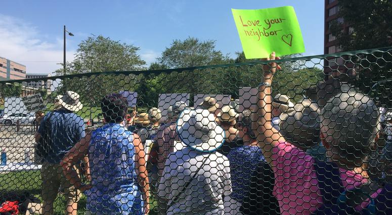 Dozens of seniors packed themselves into a small, makeshift enclosure today, and stood outside in the dangerous heat and humidity to protest migrant family separation and child detention. Dozens of seniors packed themselves into a small, makeshift enclosure today, and stood outside in the dangerous heat and humidity to protest migrant family separation and child detention.