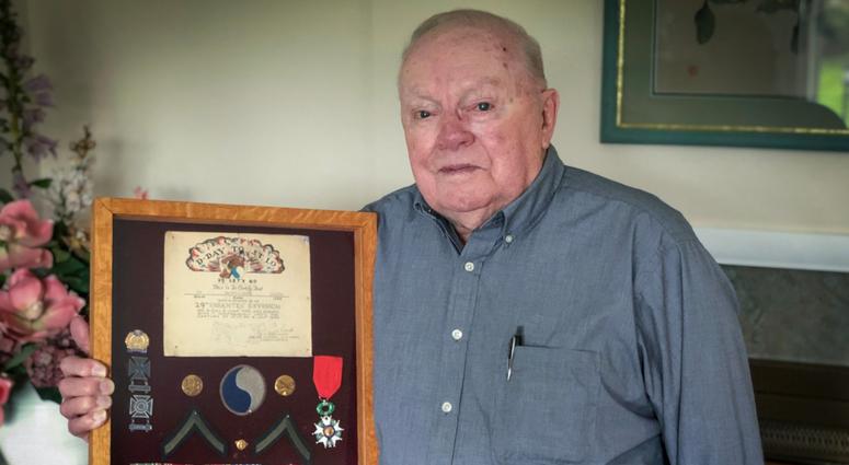 Kenneth Happel displays his honors from World War II. Kenneth Happel's honors