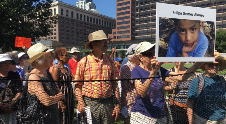 Dozens of seniors packed themselves into a small, makeshift enclosure today, and stood outside in the dangerous heat and humidity to protest migrant family separation and child detention. Dozens of seniors packed themselves into a small, makeshift enclosure today, and stood outside in the dangerous heat and humidity to protest migrant family separation and child detention.