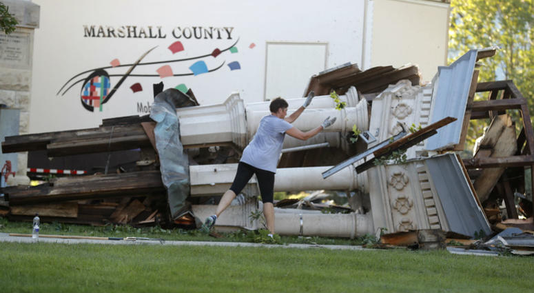 A worker cleans up debris from the tornado damaged Marshall County Courthouse's tower Thursday, July 19, 2018, in Marshalltown, Iowa. A worker cleans up debris from the tornado damaged Marshall County Courthouse's tower Thursday, July 19, 2018, in Marshalltown, Iowa.